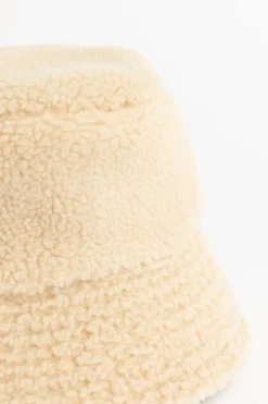 Beige reversible teddy en rib bucket hat