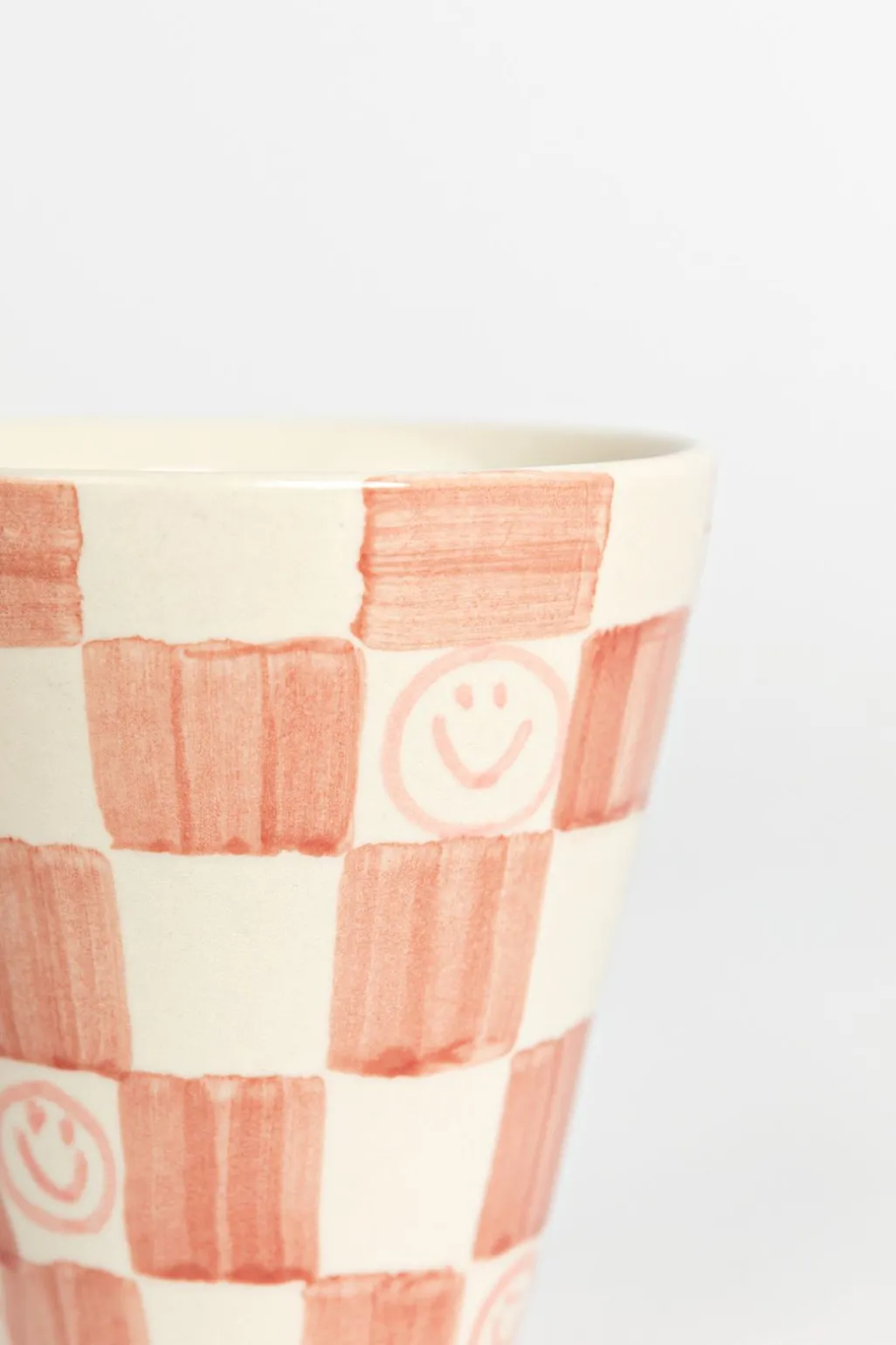 Roze geblokte beker met smileys