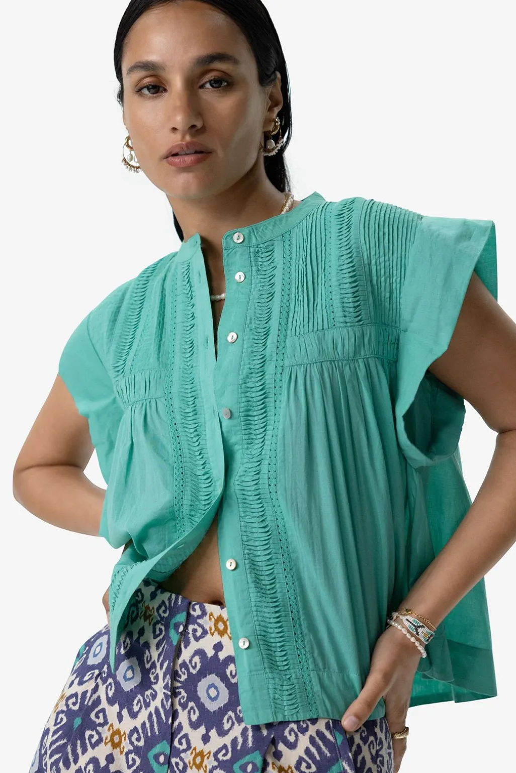 Turquoise mouwloze blouse met pintuck details